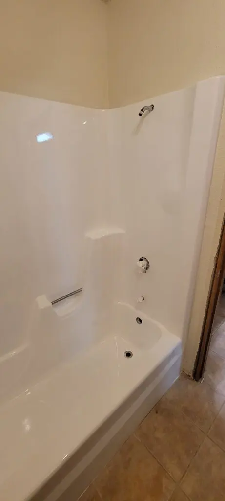 Cream-colored Tub with a removed shower head